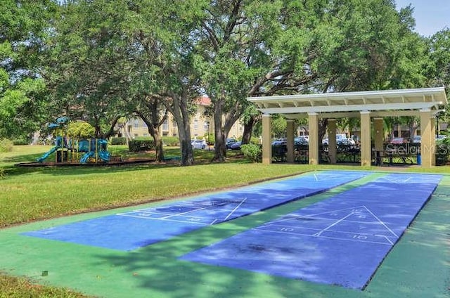 2690 Coral Landings Blvd Unit 217, Palm Harbor, FL 34684 - surrounding community featuring a lawn, shuffleboard, and uncovered parking