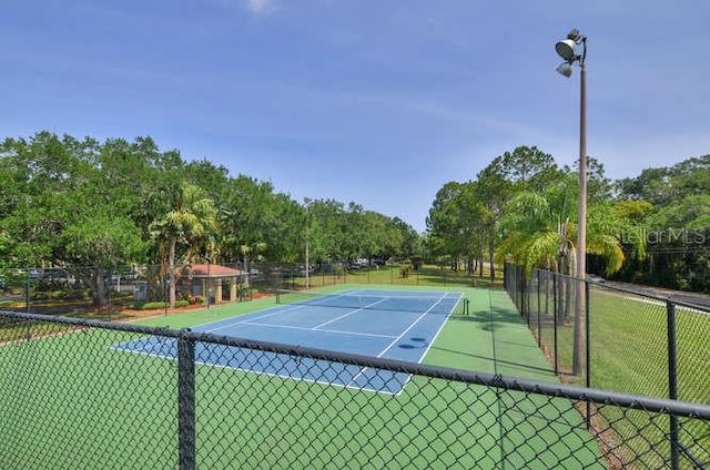 2690 Coral Landings Blvd Unit 217, Palm Harbor, FL 34684 - view of tennis court featuring view of scattered trees