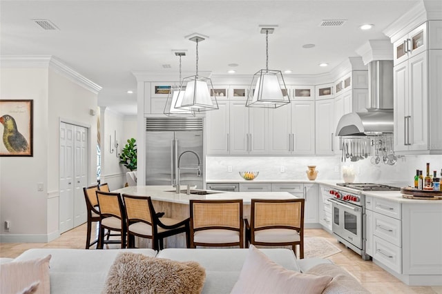 703 Monte Cristo Blvd, Tierra Verde, FL 33715 - kitchen with high quality appliances, a sink, light countertops, a kitchen island with sink, and recessed lighting