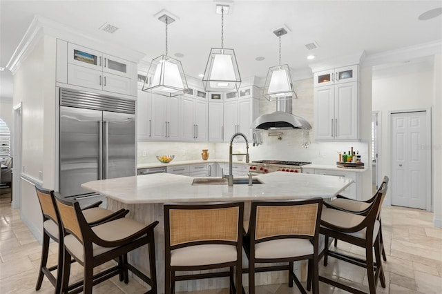 703 Monte Cristo Blvd, Tierra Verde, FL 33715 - kitchen with a sink, stone tile floors, crown molding, decorative backsplash, and stainless steel built in fridge