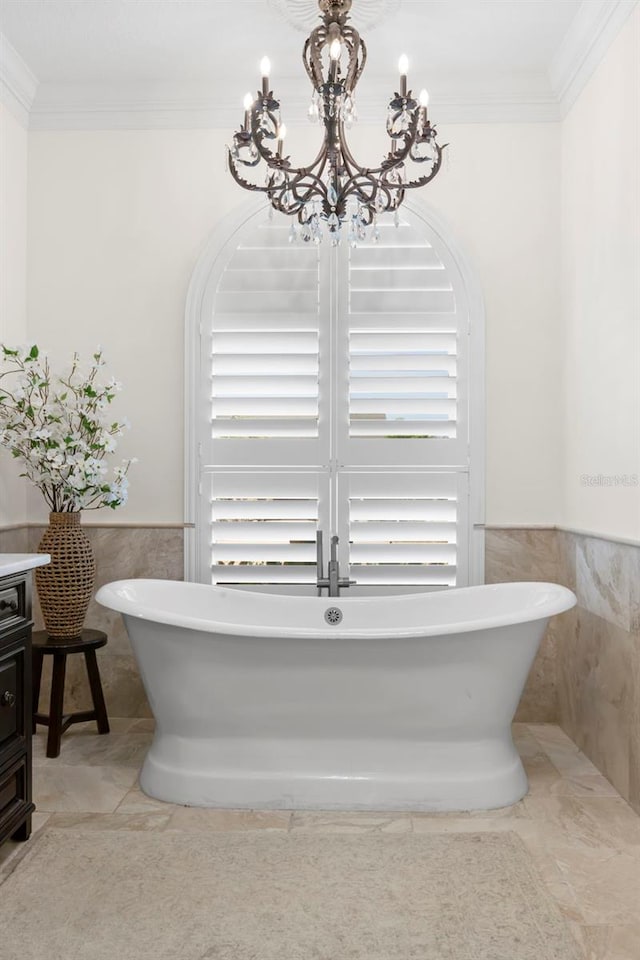 703 Monte Cristo Blvd, Tierra Verde, FL 33715 - bathroom featuring tile walls, a chandelier, a soaking tub, wainscoting, and vanity