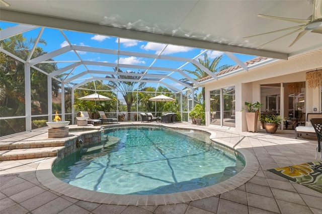 703 Monte Cristo Blvd, Tierra Verde, FL 33715 - view of swimming pool featuring a patio area, a ceiling fan, a pool with connected hot tub, and glass enclosure