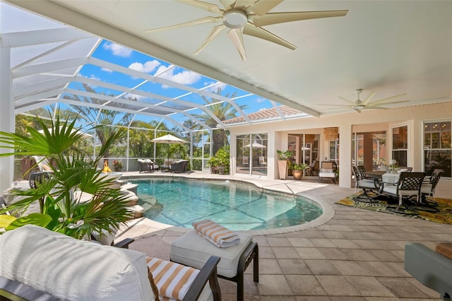 703 Monte Cristo Blvd, Tierra Verde, FL 33715 - outdoor pool with a ceiling fan, a patio area, outdoor dining space, and glass enclosure