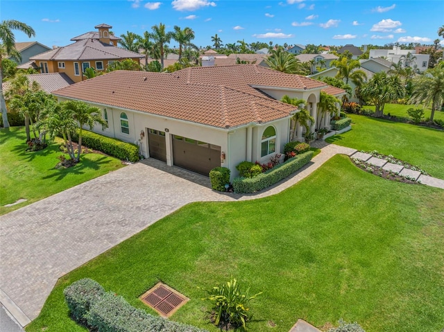 703 Monte Cristo Blvd, Tierra Verde, FL 33715 - mediterranean / spanish house featuring a garage, a tiled roof, stucco siding, a front yard, and decorative driveway
