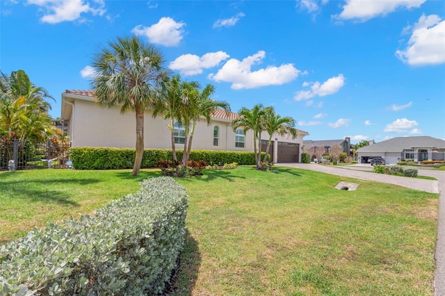 703 Monte Cristo Blvd, Tierra Verde, FL 33715 - mediterranean / spanish-style house with driveway, a garage, stucco siding, and a front lawn
