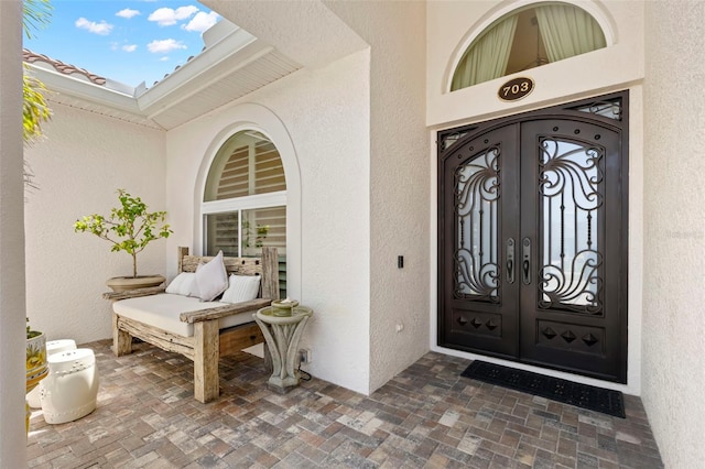 703 Monte Cristo Blvd, Tierra Verde, FL 33715 - view of exterior entry featuring french doors and stucco siding