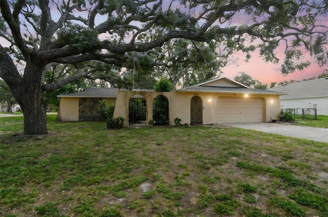 2410 Covington Ave, Spring Hill, FL 34608 - single story home featuring stucco siding, driveway, a garage, and a yard