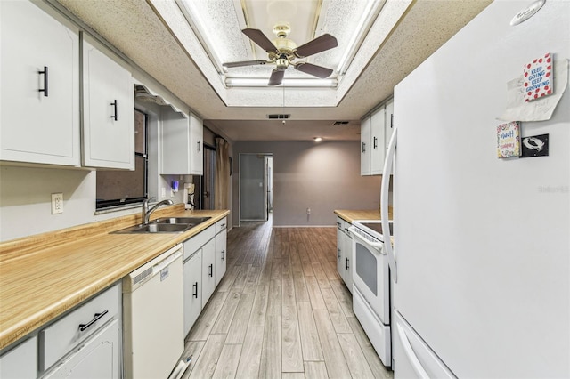 2410 Covington Ave, Spring Hill, FL 34608 - kitchen featuring white appliances, a sink, white cabinets, light wood finished floors, and ceiling fan