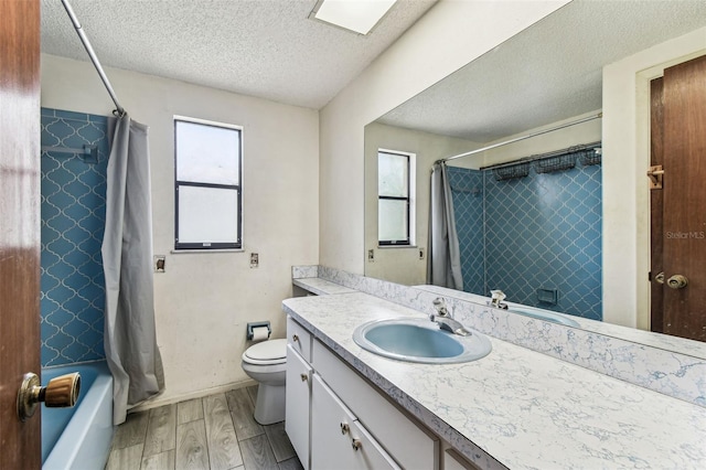 2410 Covington Ave, Spring Hill, FL 34608 - full bath featuring plenty of natural light, a textured ceiling, vanity, wood finished floors, and shower / tub combo with curtain