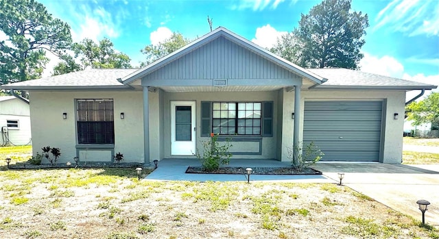 13100 Serpentine Dr, Hudson, FL 34667 - view of front of home with an attached garage, concrete driveway, stucco siding, and covered porch