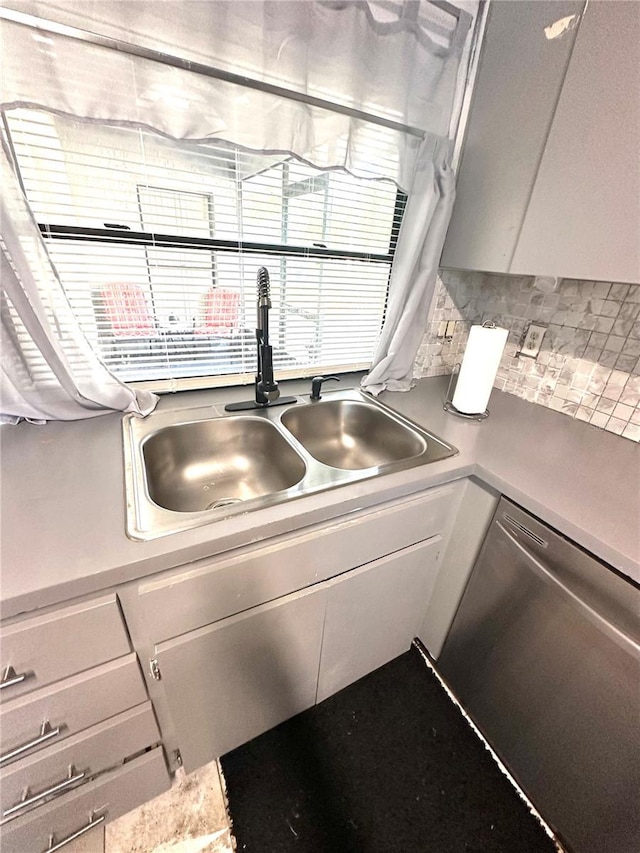 13100 Serpentine Dr, Hudson, FL 34667 - kitchen view of a sink, stainless steel dishwasher, backsplash, and light countertops