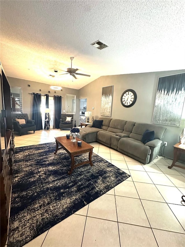 13100 Serpentine Dr, Hudson, FL 34667 - tiled living room with a textured ceiling, ceiling fan, and lofted ceiling