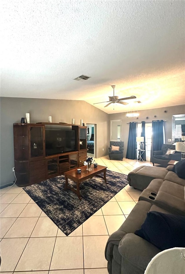 13100 Serpentine Dr, Hudson, FL 34667 - living room featuring a textured ceiling, light tile patterned floors, lofted ceiling, and ceiling fan