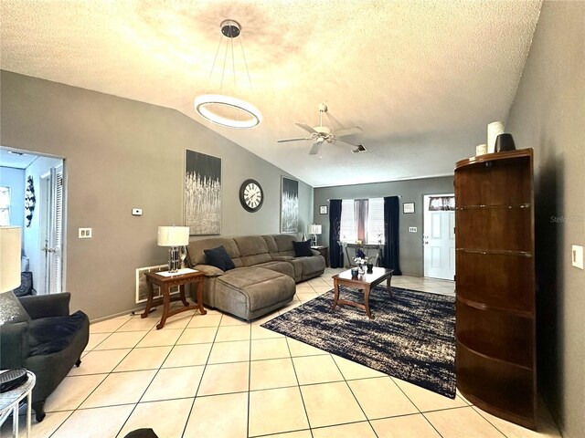 13100 Serpentine Dr, Hudson, FL 34667 - living room with vaulted ceiling, a ceiling fan, light tile patterned floors, and a textured ceiling