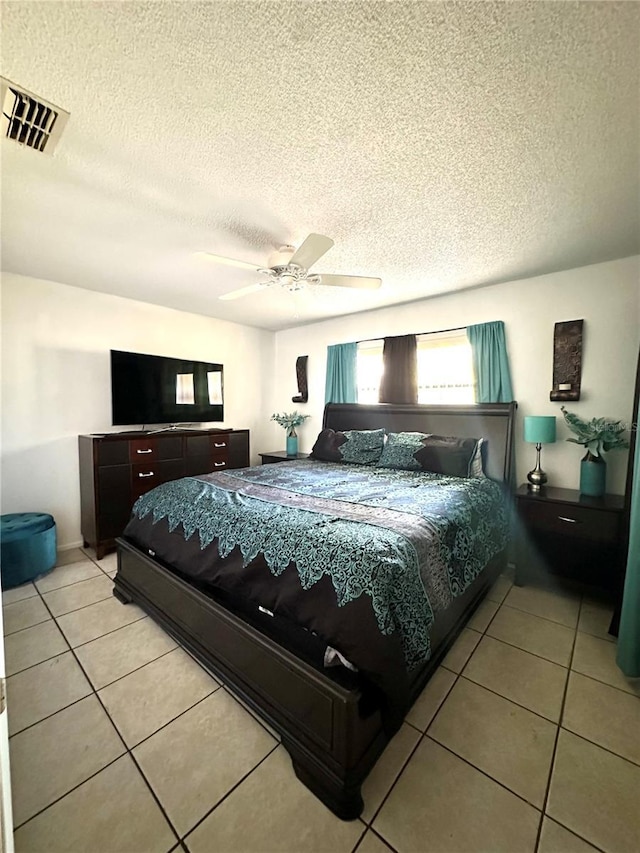 13100 Serpentine Dr, Hudson, FL 34667 - bedroom featuring light tile patterned flooring, a textured ceiling, and ceiling fan