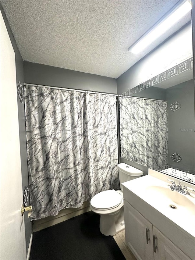 13100 Serpentine Dr, Hudson, FL 34667 - bathroom with a textured ceiling, vanity, and toilet