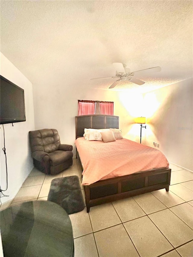 13100 Serpentine Dr, Hudson, FL 34667 - bedroom with tile patterned floors, a textured ceiling, and ceiling fan