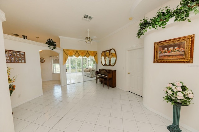3010 Grand View Ave, Clearwater, FL 33759 - empty room with arched walkways, ceiling fan, ornamental molding, baseboards, and light tile patterned floors