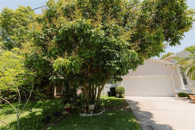 3010 Grand View Ave, Clearwater, FL 33759 - obstructed view of property featuring driveway, stucco siding, and a garage