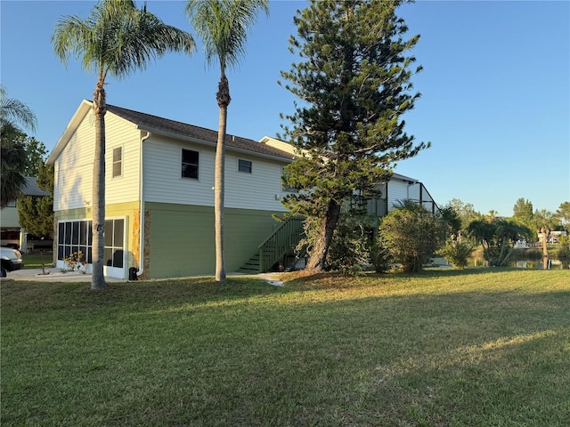 3338 Fernleaf Dr, Hernando Beach, FL 34607 - view of side of property with a yard and stairway