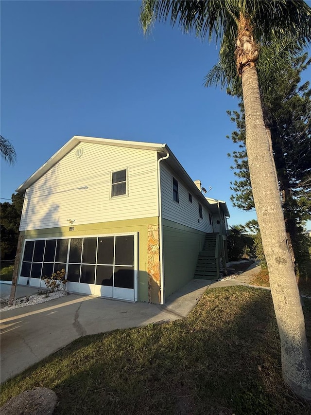 3338 Fernleaf Dr, Hernando Beach, FL 34607 - rear view of property featuring a garage