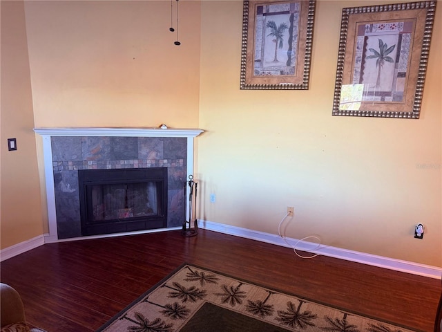 3338 Fernleaf Dr, Hernando Beach, FL 34607 - detailed view of wood finished floors, baseboards, and a tile fireplace