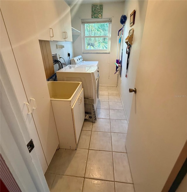 3338 Fernleaf Dr, Hernando Beach, FL 34607 - laundry area featuring washer and clothes dryer, cabinet space, and light tile patterned floors