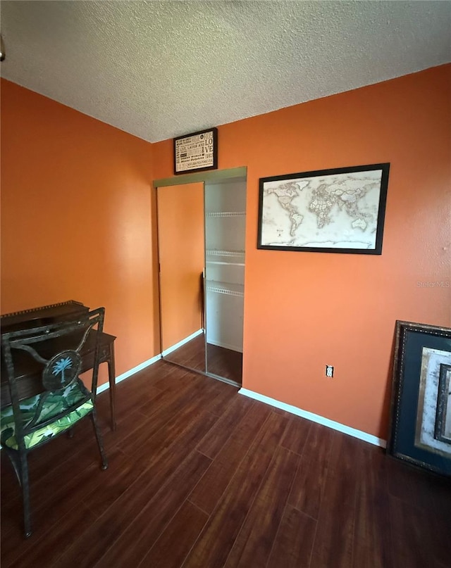 3338 Fernleaf Dr, Hernando Beach, FL 34607 - bedroom featuring dark wood-style flooring, baseboards, and a textured ceiling