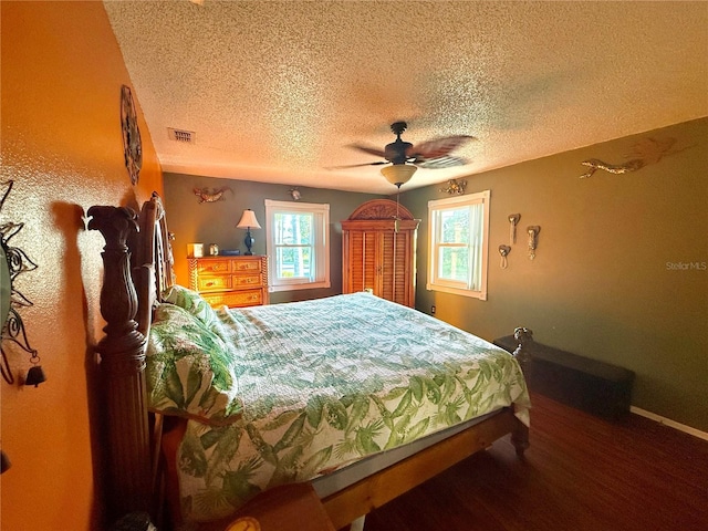 3338 Fernleaf Dr, Hernando Beach, FL 34607 - bedroom with a textured ceiling, baseboards, wood finished floors, and a ceiling fan
