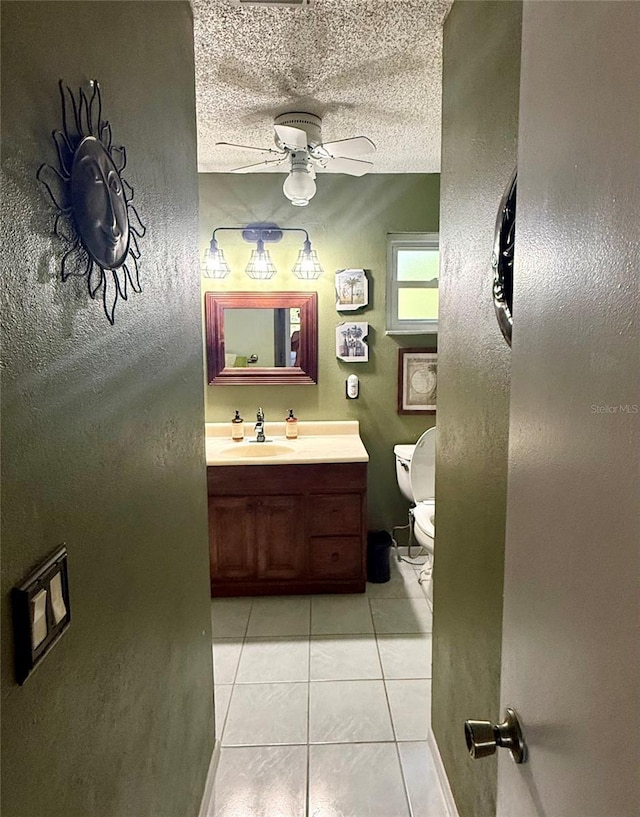 3338 Fernleaf Dr, Hernando Beach, FL 34607 - bathroom with ceiling fan, tile patterned flooring, toilet, vanity, and a textured ceiling