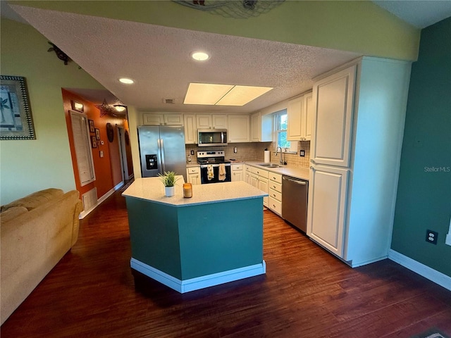 3338 Fernleaf Dr, Hernando Beach, FL 34607 - kitchen with appliances with stainless steel finishes, a sink, white cabinets, light countertops, and baseboards