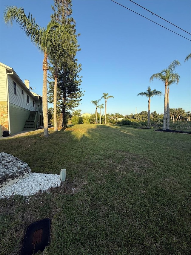 3338 Fernleaf Dr, Hernando Beach, FL 34607 - view of grassy yard with stairs