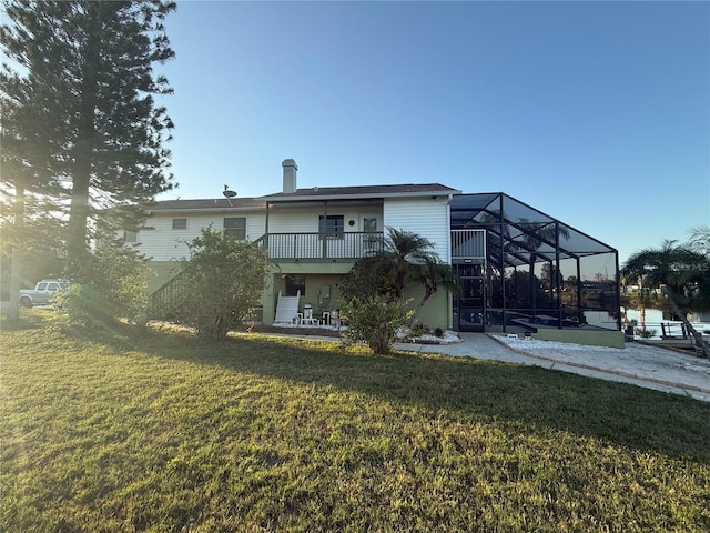 3338 Fernleaf Dr, Hernando Beach, FL 34607 - back of house featuring a yard, a patio area, a balcony, and a lanai