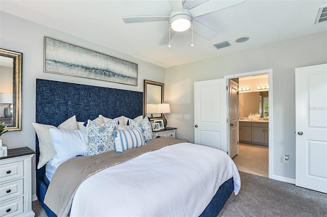 12435 Gust Ct, Hudson, FL 34669 - bedroom with carpet flooring, ensuite bath, and ceiling fan