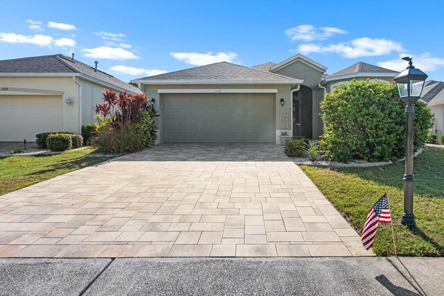 1110 Jasmine Creek Ct, Sun City Center, FL 33573 - ranch-style house featuring decorative driveway, stucco siding, and a garage