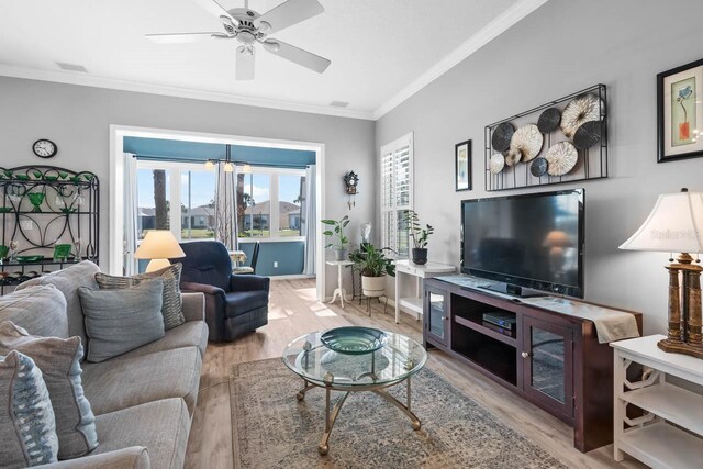 1110 Jasmine Creek Ct, Sun City Center, FL 33573 - living area featuring wood finished floors, crown molding, ceiling fan, and baseboards