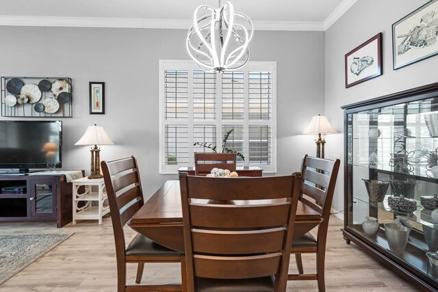 1110 Jasmine Creek Ct, Sun City Center, FL 33573 - dining room with a chandelier, light wood-type flooring, and ornamental molding
