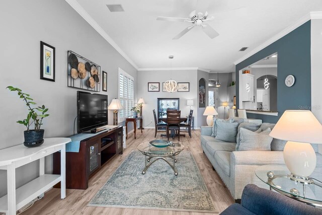 1110 Jasmine Creek Ct, Sun City Center, FL 33573 - living area featuring light wood-style flooring, a ceiling fan, crown molding, and baseboards