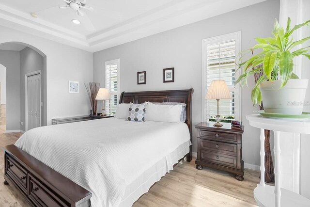 1110 Jasmine Creek Ct, Sun City Center, FL 33573 - bedroom featuring arched walkways, light wood-style floors, baseboards, and recessed lighting