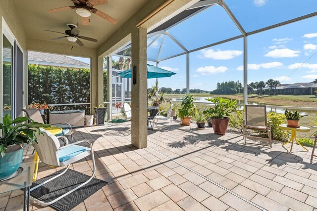 1110 Jasmine Creek Ct, Sun City Center, FL 33573 - view of patio featuring glass enclosure, ceiling fan, and a water view