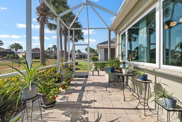1110 Jasmine Creek Ct, Sun City Center, FL 33573 - view of patio with glass enclosure and a residential view