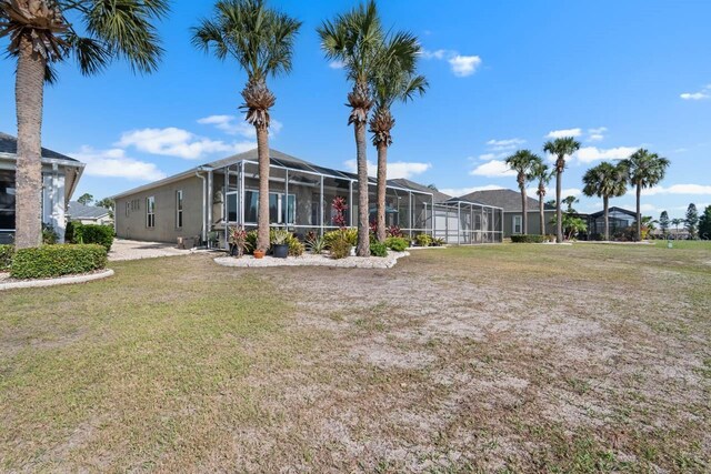 1110 Jasmine Creek Ct, Sun City Center, FL 33573 - view of green lawn featuring a lanai