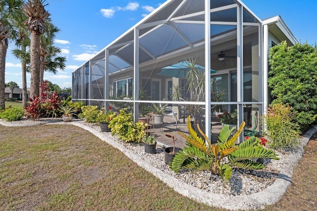 1110 Jasmine Creek Ct, Sun City Center, FL 33573 - back of house with ceiling fan, a yard, a patio, and a lanai