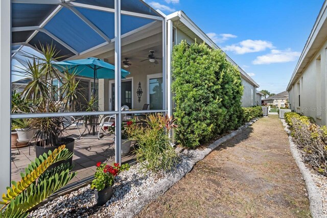 1110 Jasmine Creek Ct, Sun City Center, FL 33573 - view of side of property featuring ceiling fan, a patio area, outdoor dining space, and central AC unit