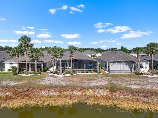 1110 Jasmine Creek Ct, Sun City Center, FL 33573 - back of house featuring a water view, a residential view, and a lanai