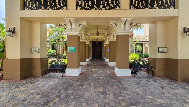 1110 Jasmine Creek Ct, Sun City Center, FL 33573 - doorway to property featuring stucco siding