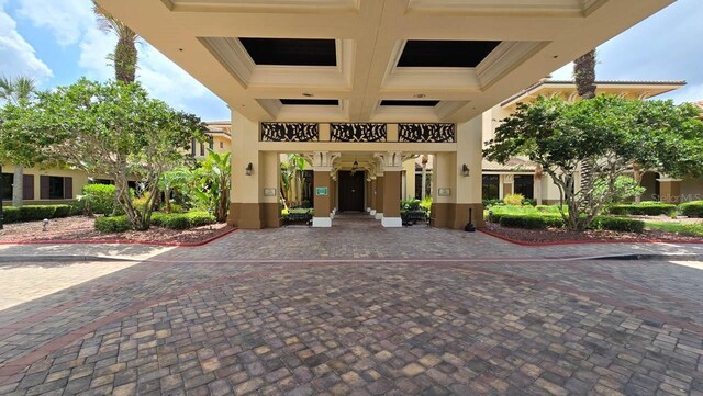 1110 Jasmine Creek Ct, Sun City Center, FL 33573 - view of exterior entry featuring a carport and stucco siding