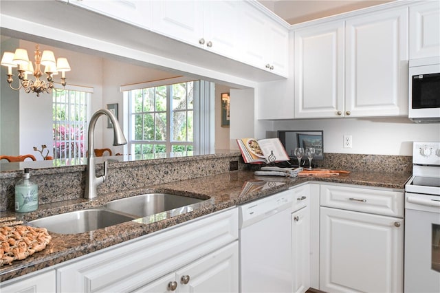 14840 Shipwatch Trce Unit 1924, Largo, FL 33774 - kitchen featuring white appliances, a sink, white cabinets, a chandelier, and dark stone countertops