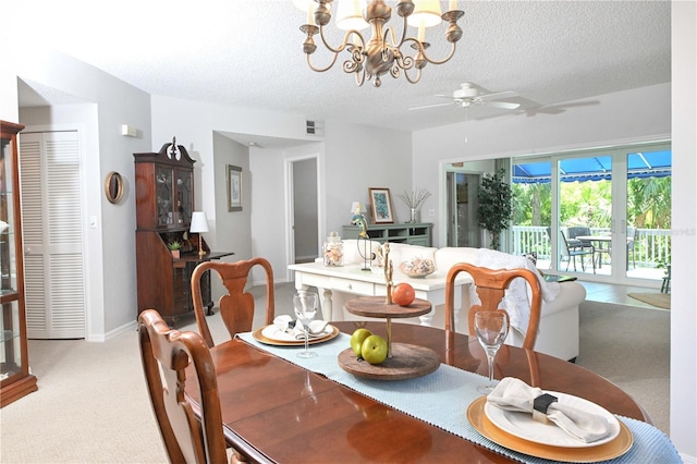 14840 Shipwatch Trce Unit 1924, Largo, FL 33774 - dining room featuring light carpet, a textured ceiling, a chandelier, a ceiling fan, and baseboards