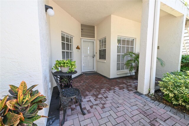14840 Shipwatch Trce Unit 1924, Largo, FL 33774 - doorway to property featuring stucco siding and a patio area